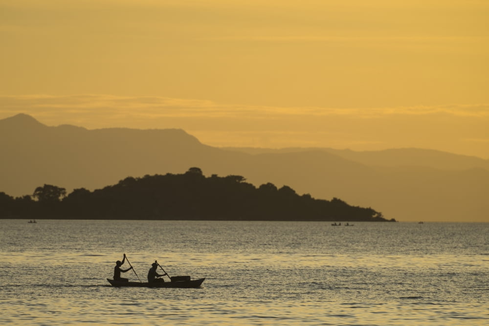 Silhouette of fishermen in dugout canoe leaving Cape Maclear in the evening Lake Malawi Malawi Canvas Art - Ian Cumming Design Pics (19 x 12)