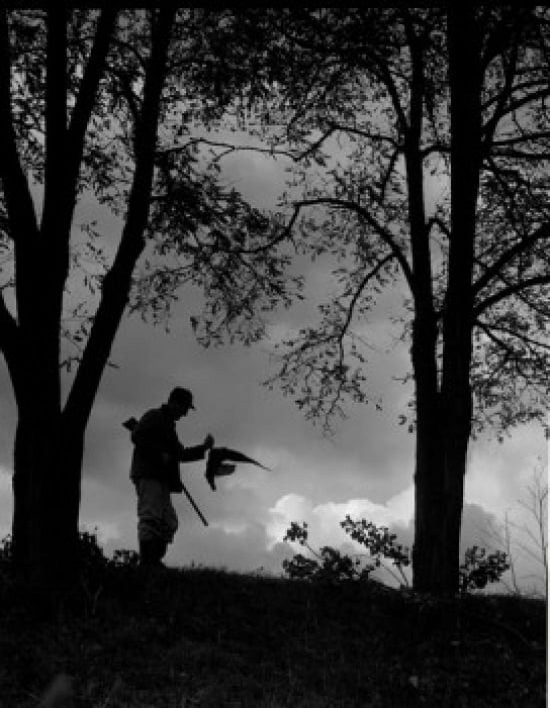 Silhouette of man with gun going for hunting Canvas Art - (24 x 36)