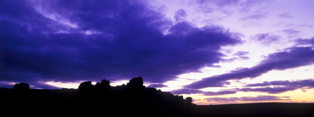 Silhouette of rock formations at dusk Dartmoor National Park Devon England Canvas Art - Panoramic Images (36 x 12)