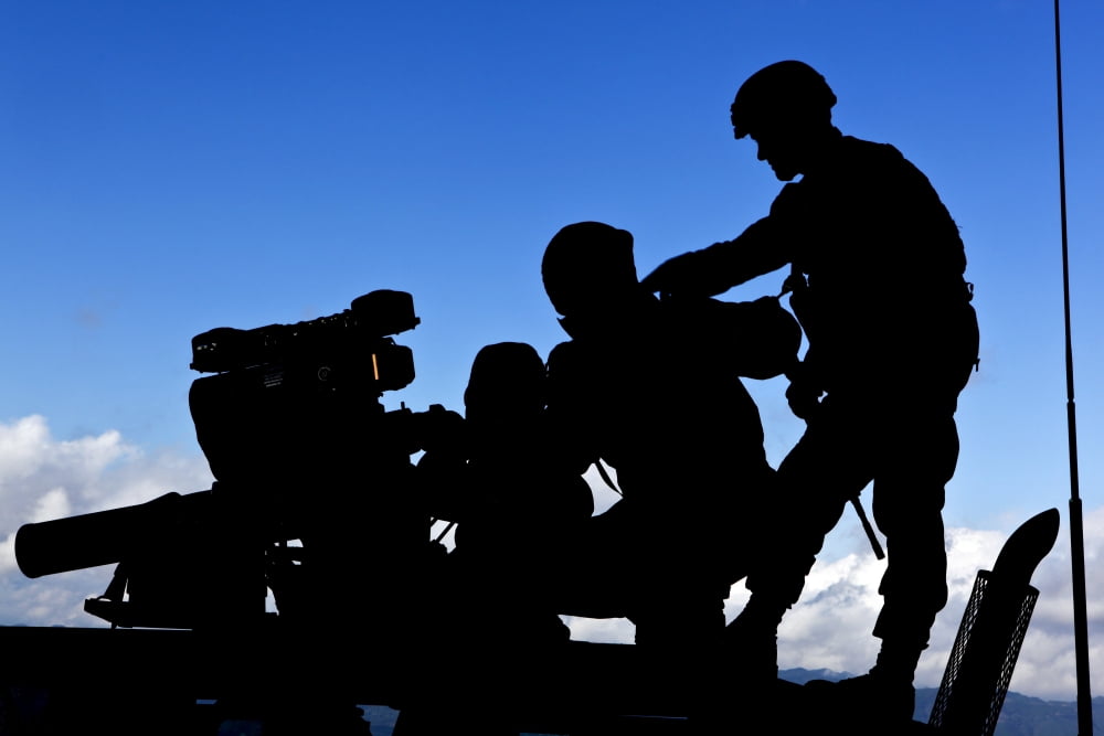 Silhouette of soldiers operating a BGM-71 TOW guided missile system Canvas Art - Stocktrek Images (34 x 23)