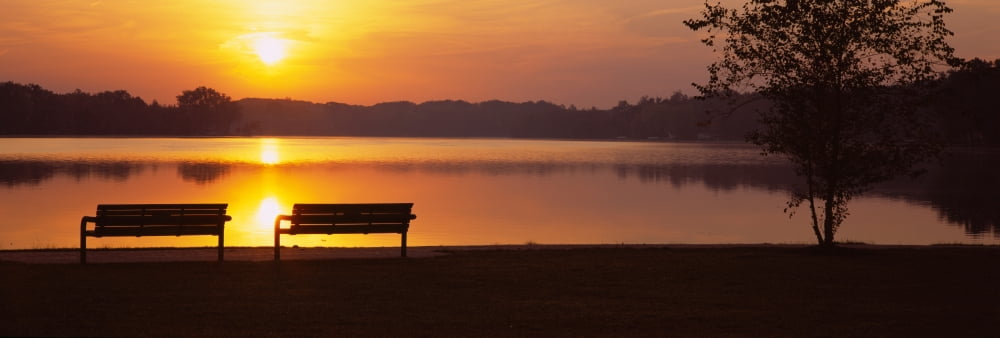 Silhouette of two benches along a lake Reeds Lake Grand Rapids Michigan USA Canvas Art - Panoramic Images (36 x 12)