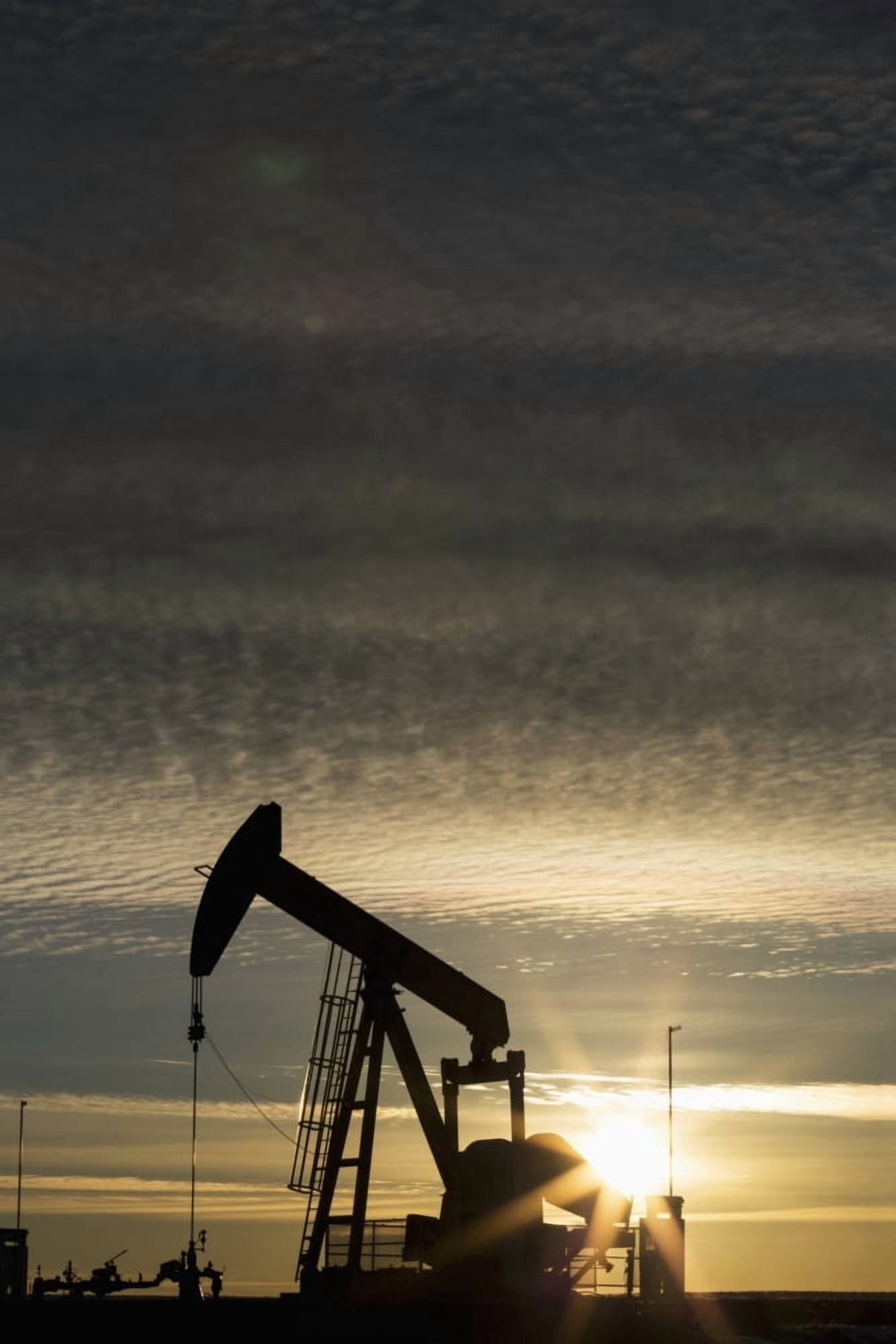 Silhouette of pump jack at sunrise with sun burst and colourful clouds in the sky Alberta Canada Canvas Art - Michael Interisano Design Pics (12 x 19)