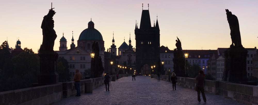 Silhouette of statues on Charles Bridge with St Francis Church and Old Town Bridge Tower in the background Prague Czech Republic Canvas Art - Panoramic Images (36 x 12)