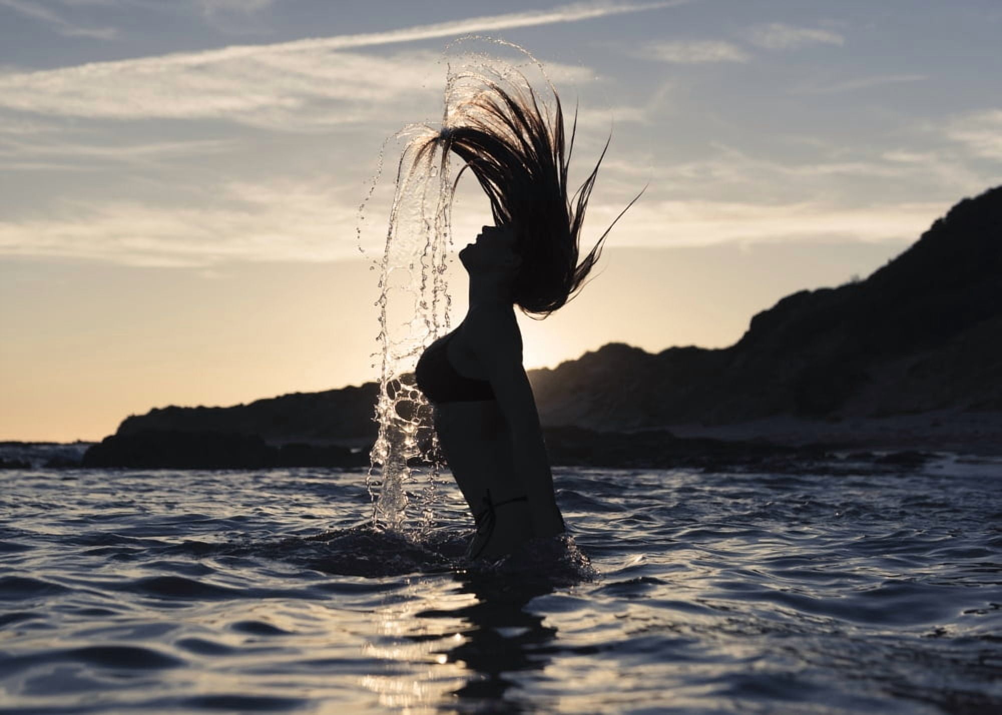 Silhouette of a woman in waist-deep water flipping her wet long hair up in the air Tarifa Cadiz Andalusia Spain Canvas Art - Ben Welsh Design Pics (18 x 13)