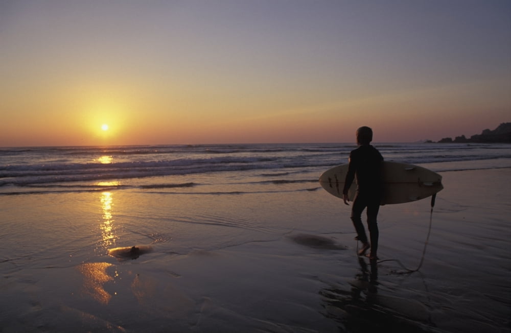 Silhouetted Surfer On Sandy Beach At Sunset Canvas Art - Chris Martin Design Pics (36 x 22)