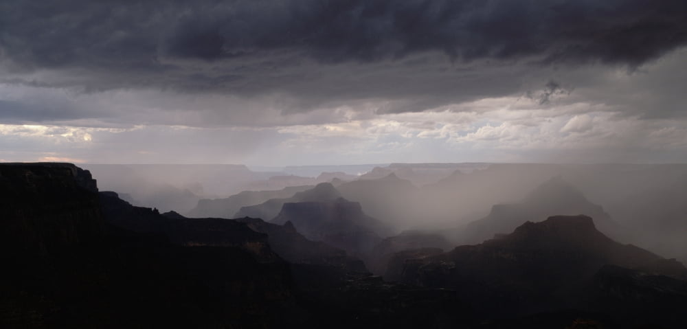 Silhouetted ridge of the Inner Canyon and rainstorm over the Grand Canyon from Yaki Point in the evening Grand Canyon National Park Arizona Canvas Art - Panoramic Images (36 x 12)