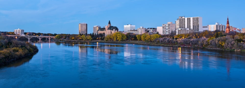 Skylines at waterfront South Saskatchewan River Saskatoon Saskatchewan Canada Canvas Art - Panoramic Images (13 x 36)