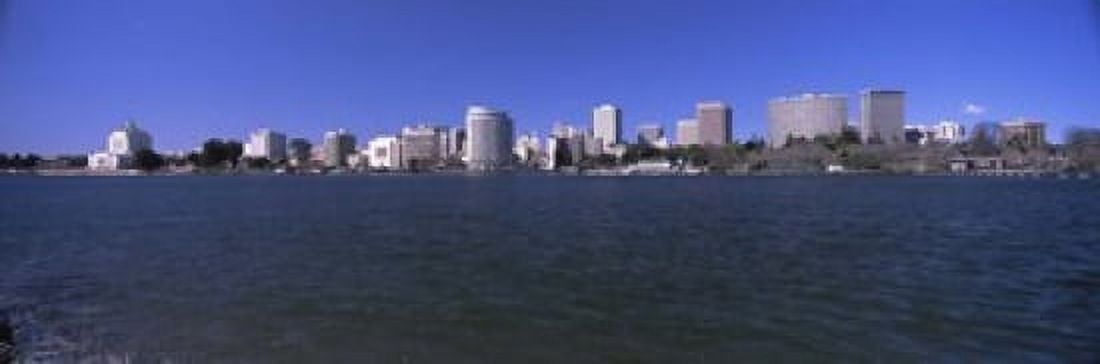 Skyscrapers along a lake Lake Merritt Oakland California USA Canvas Art - Panoramic Images (18 x 6)