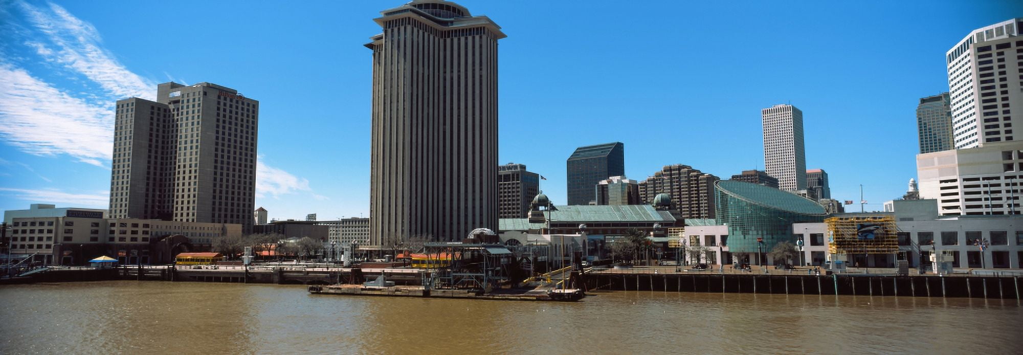 Skyscrapers at the waterfront Trade Mart Tower River Mississippi New Orleans Louisiana USA Canvas Art - Panoramic Images (27 x 9)