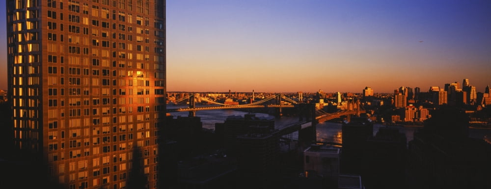 Skyscrapers in a city at sunset New York City New York State USA Canvas Art - Panoramic Images (32 x 12)