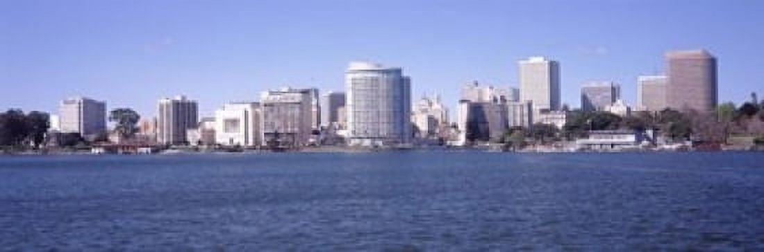 Skyscrapers in a lake Lake Merritt Oakland California USA Canvas Art - Panoramic Images (18 x 6)