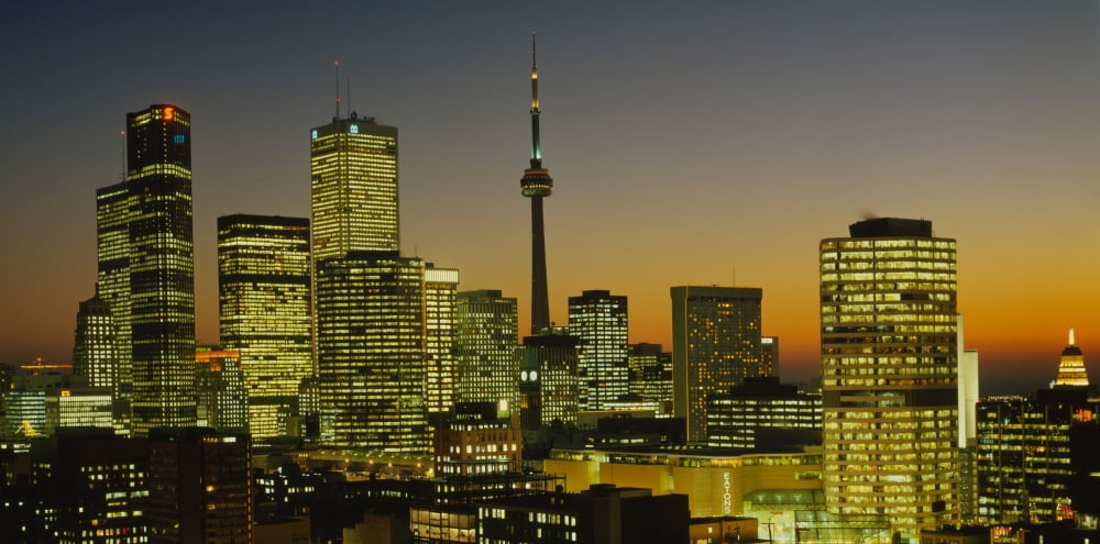 Skyscrapers lit up at dusk Toronto Eaton Centre Toronto Ontario Canada Canvas Art - Panoramic Images (27 x 9)