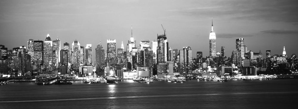 Skyscrapers lit up at night in a city Manhattan New York City New York State USA Canvas Art - Panoramic Images (13 x 36)