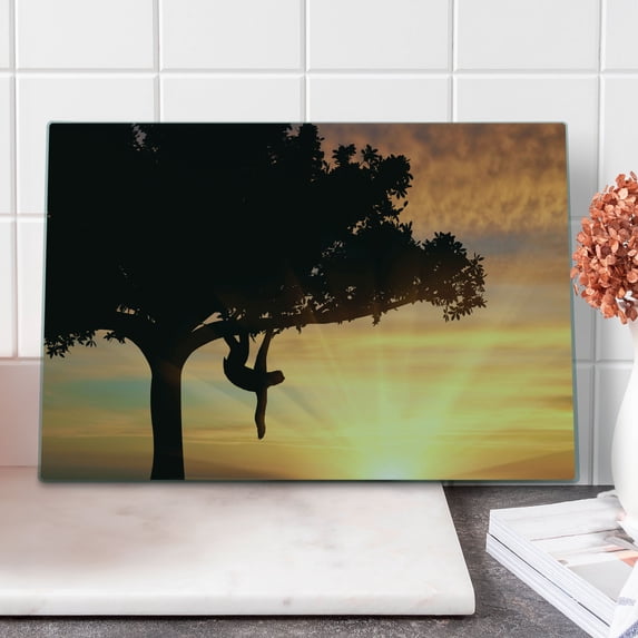 Sloth Cutting Board, Sunset View at Nature Reserve Exotic Animal Hangs on Big Tree Fauna Jungle, Decorative Tempered Glass Cutting and Serving Board, Large Size, Peach Black Yellow, by Ambesonne