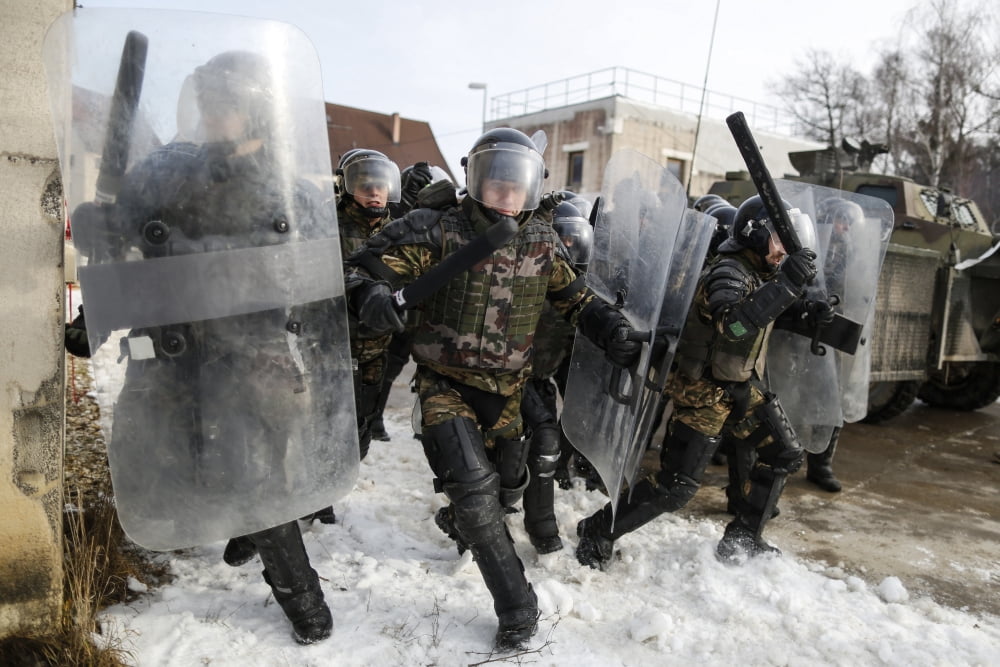 Slovenian soldiers rush around a corner while conducting riot control training Canvas Art - Stocktrek Images (34 x 23)