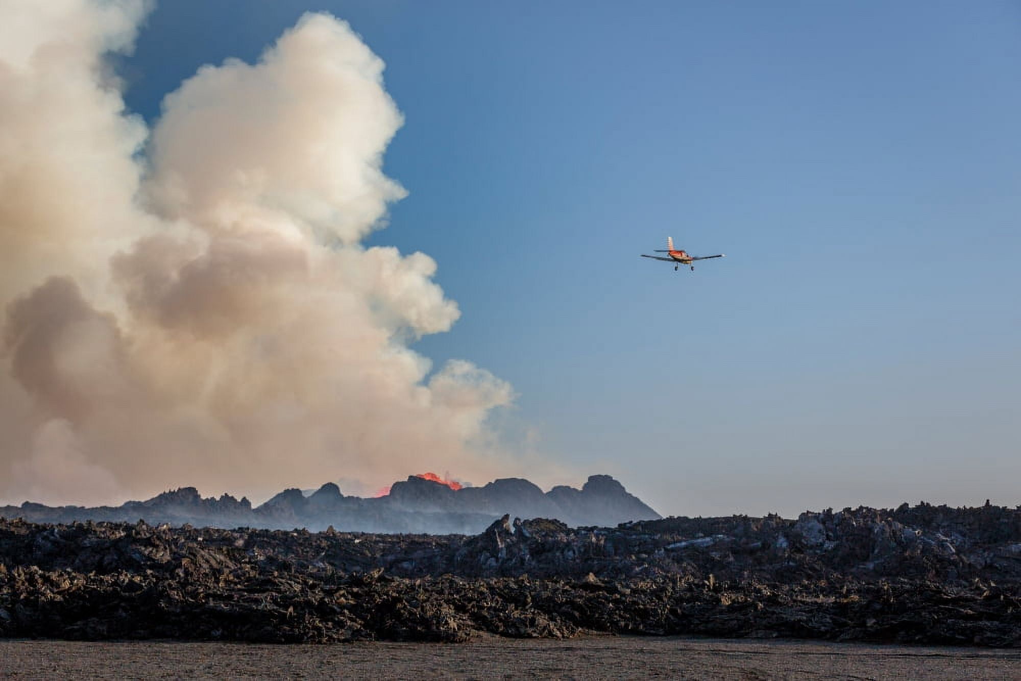 Small airplane flying by the Volcano Eruption at the Holuhraun Fissure Bardarbunga Volcano Iceland Canvas Art - Panoramic Images (27 x 9)