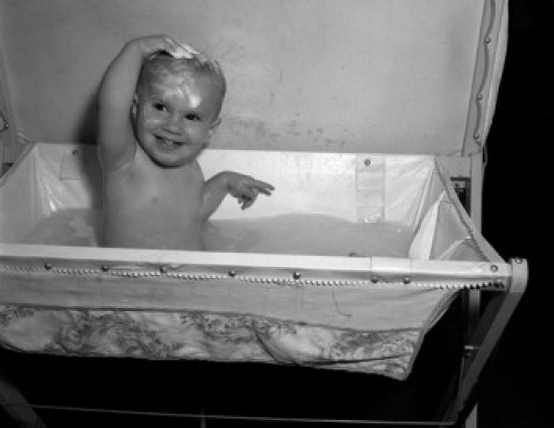 Small baby sitting in baby bathtub and smiling Canvas Art - (24 x 36)