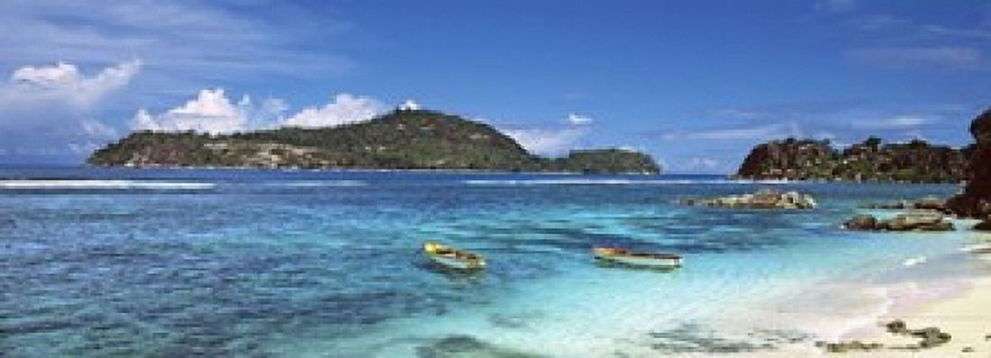 Small fishing boats on Anse LIslette with Therese Island in background Seychelles Canvas Art - Panoramic Images (18 x 7)