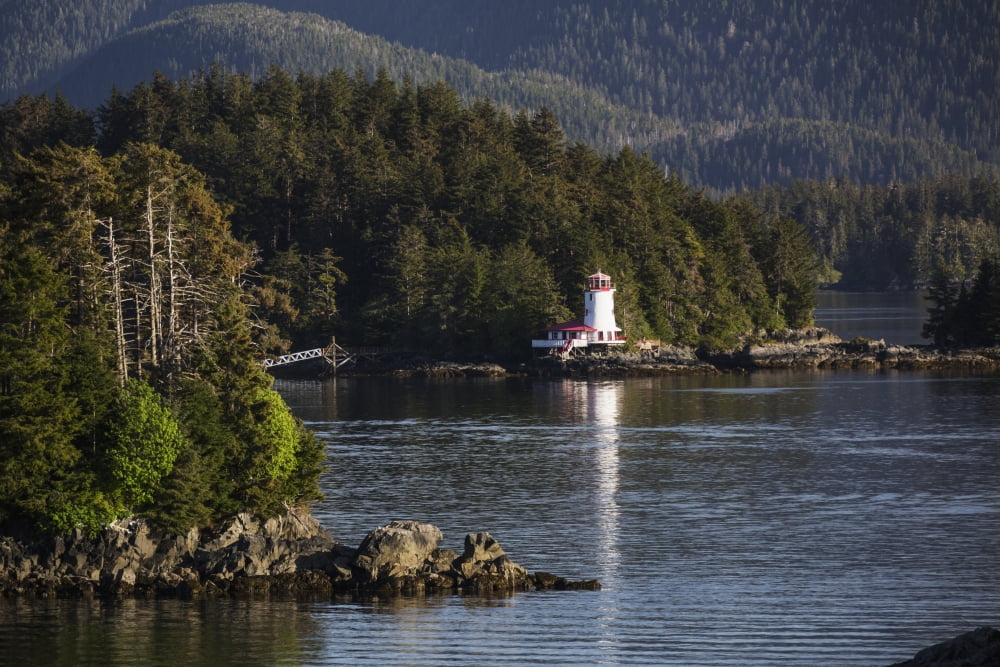 Small islands populated by Sitka spruce trees a lighthouse in the background Sitka Alaska United States of America Canvas Art - Kevin Smith Design Pics (19 x 12)