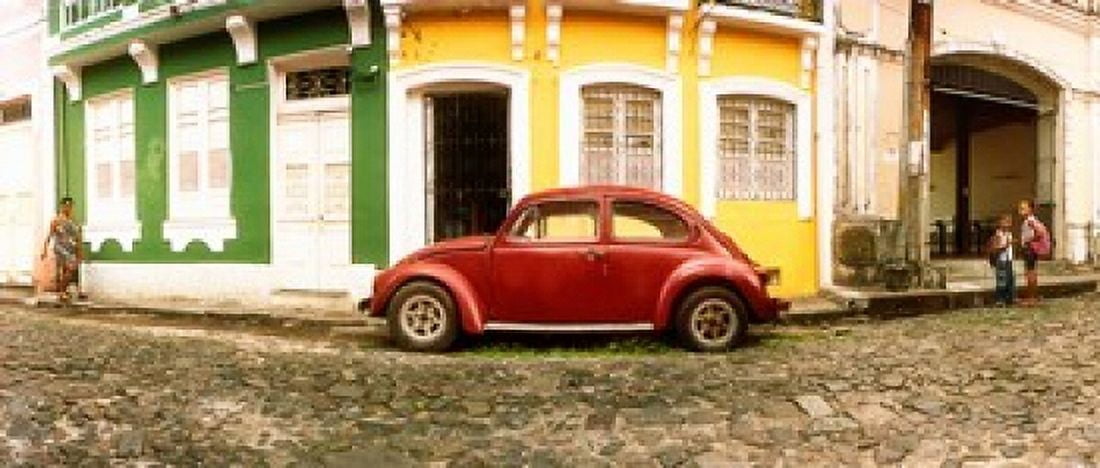 Small old red car parked in front of colorful building Pelourinho Salvador Bahia Brazil Canvas Art - Panoramic Images (30 x 13)