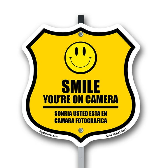 Smile You're On Camera Bilingual English / Spanish 12 inch X 12 inch Shield Shaped Commercial Grade Plastic Sign with Aluminum Mounting Stake Weather Resistant Made in the USA