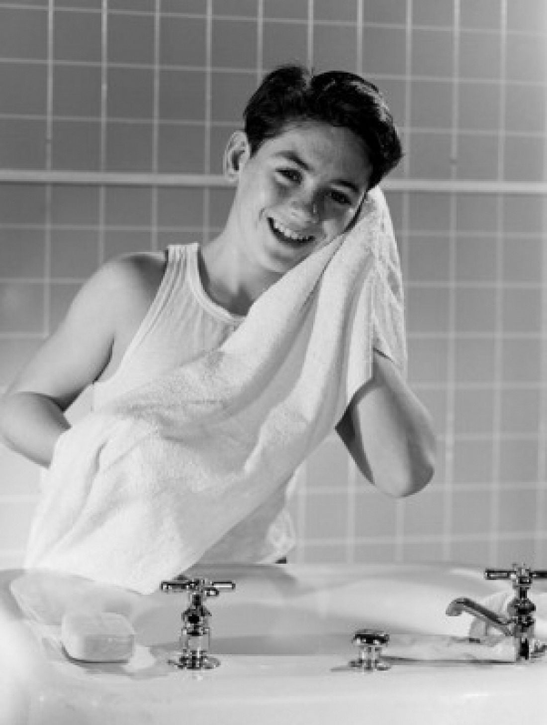 Smiling boy drying face with towel in bathroom Canvas Art -  (24 x 36)