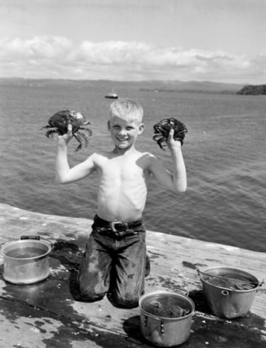 Smiling boy holding crabs on seaside Canvas Art - (18 x 24)