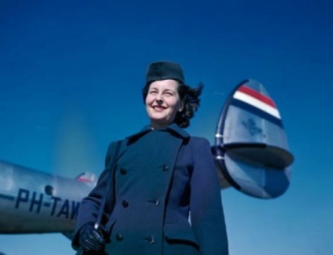 Smiling female cabin crew member standing near airplane against blue sky Canvas Art - (24 x 36)
