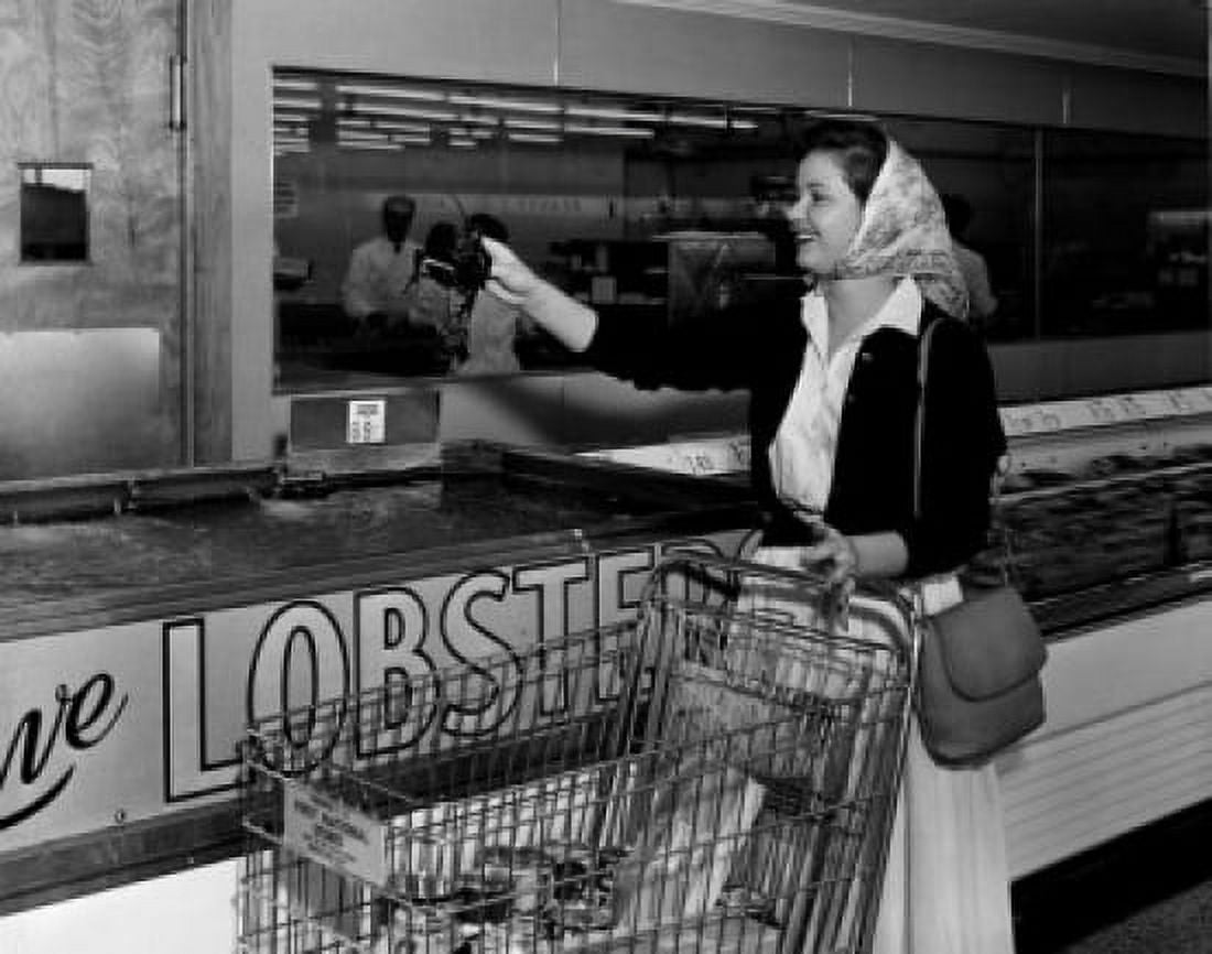 Smiling woman holding lobster in supermarket Canvas Art - (18 x 24)