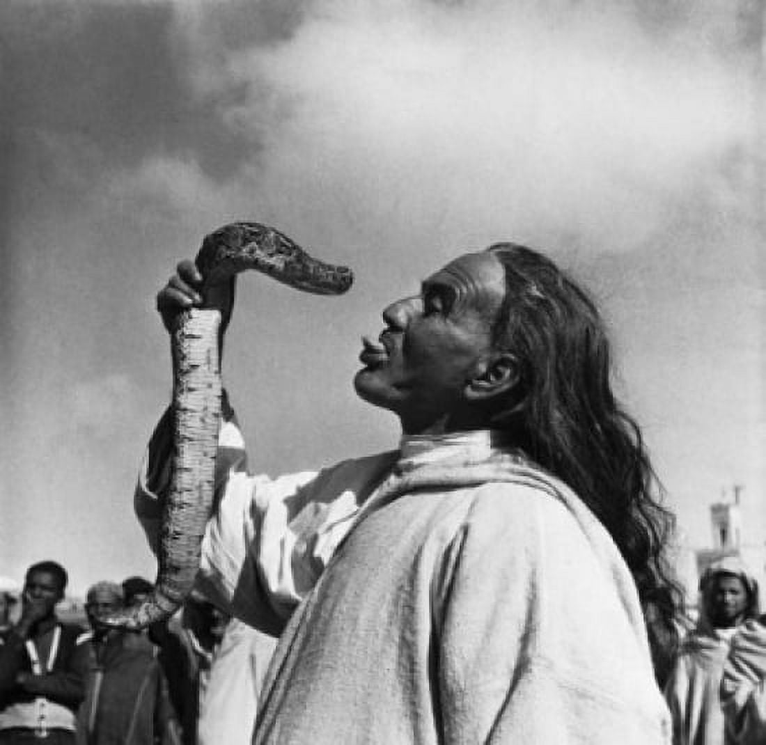 Snake charmer sticking his tongue out and holding a snake Marrakesh Morocco Canvas Art - (18 x 24)
