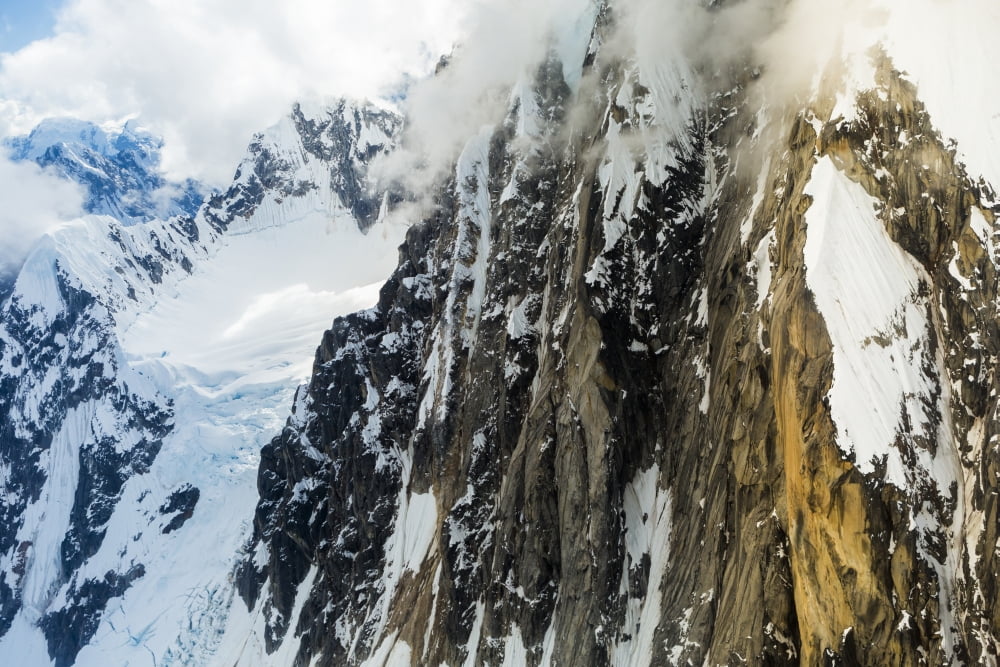Snow and the rugged rock face of a mountain Alaska United States of America Canvas Art - Michael DeYoung Design Pics (38 x 24)