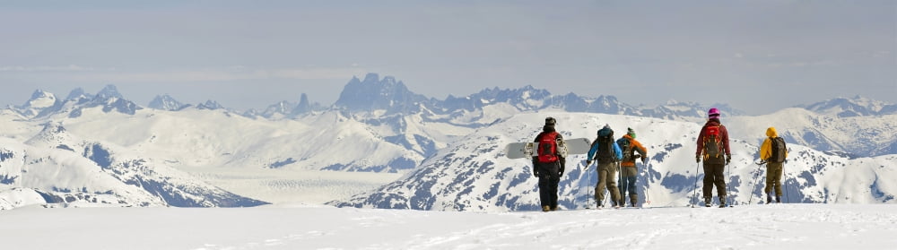 A Snowboarder And Skiers Hike Along The West Ridge Of Mt Hawthorne Overlooking The Juneau Ice Field And Devils Paw While Heliskiing Near Juneau Alaska Canvas Art - Chris Miller Design Pics (40 x 11)