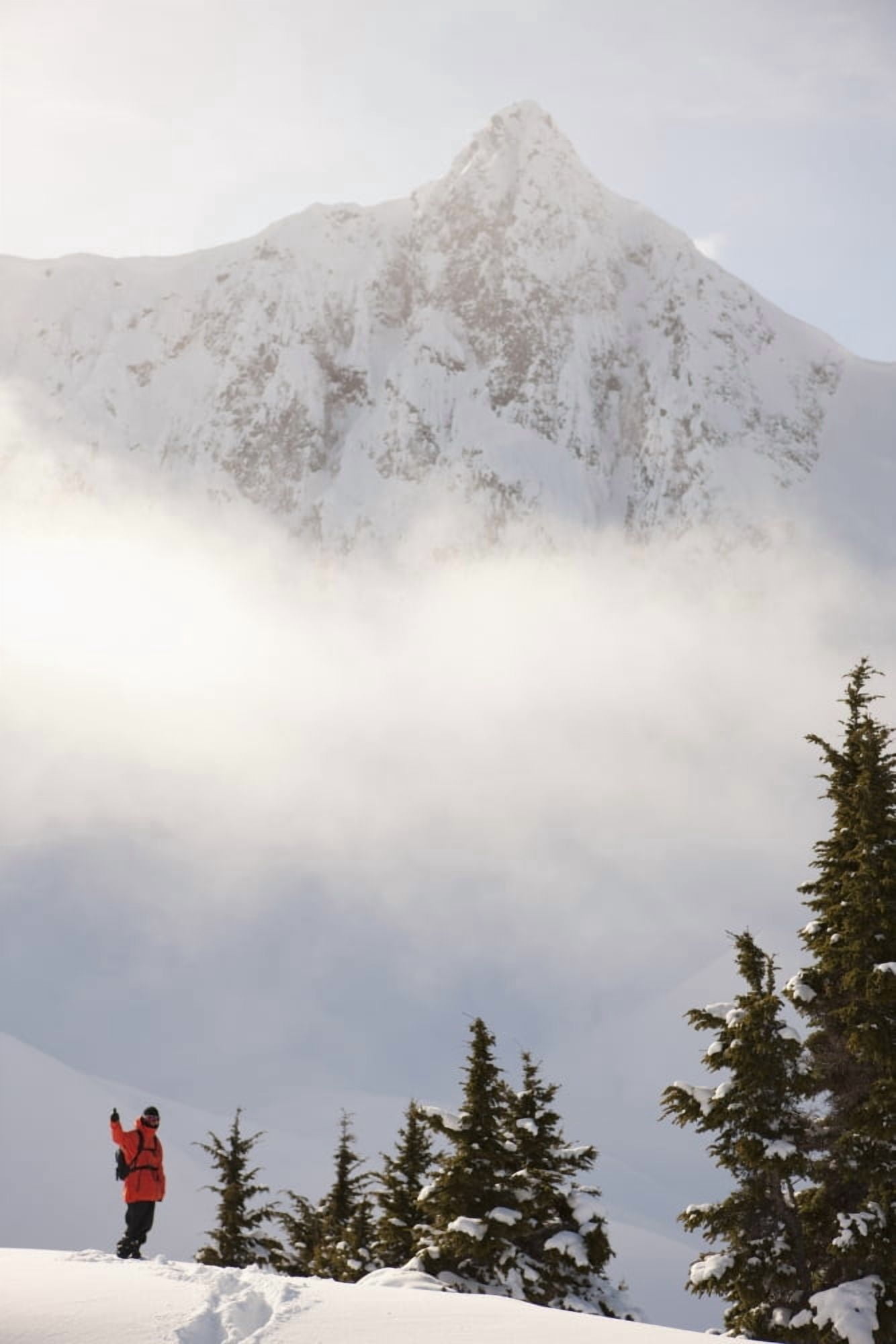 Snowboarder on a ridge with scenic mountains and fog in the background Haines Southeast Alaska Canvas Art - Dean Blotto Gray Design Pics (12 x 19)