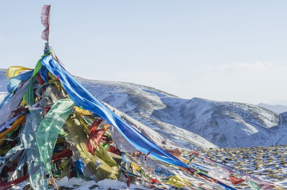 Snowy landscape with prayer flags on a high altitude mountain pass Tibet Canvas Art - Sergey Orlov Design Pics (19 x 12)