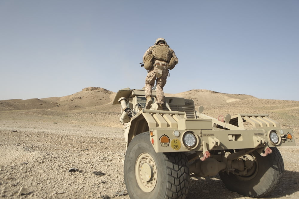 Soldier climbs a damaged Husky Tactical Support Vehicle Canvas Art - Stocktrek Images (35 x 23)