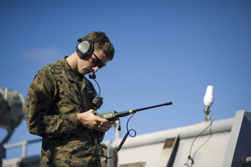 Soldier conducts a communications check aboard USS Pearl Harbor Canvas Art - Stocktrek Images (35 x 23)