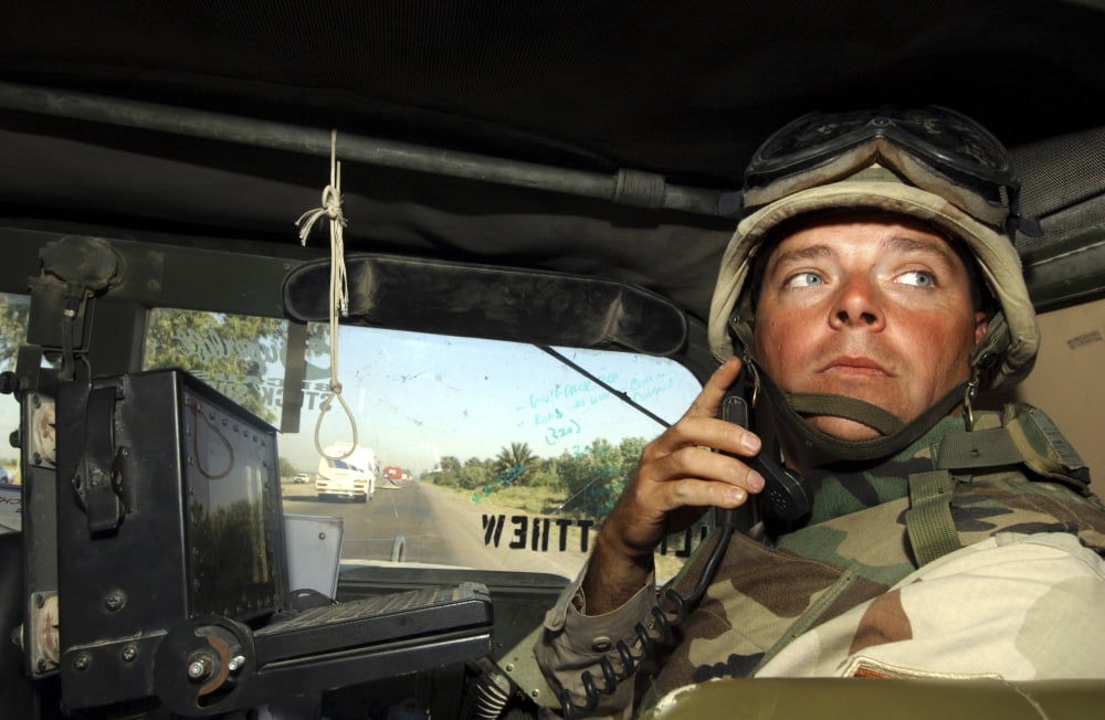 Soldier monitors the progress of a 67 vehicle convoy along the Main Supply Route Canvas Art - Stocktrek Images (35 x 23)