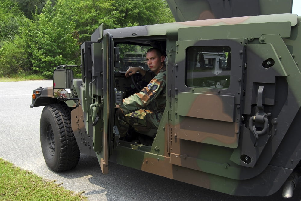 Soldier performs an inspection of an armored Humvee Canvas Art - Stocktrek Images (34 x 23)