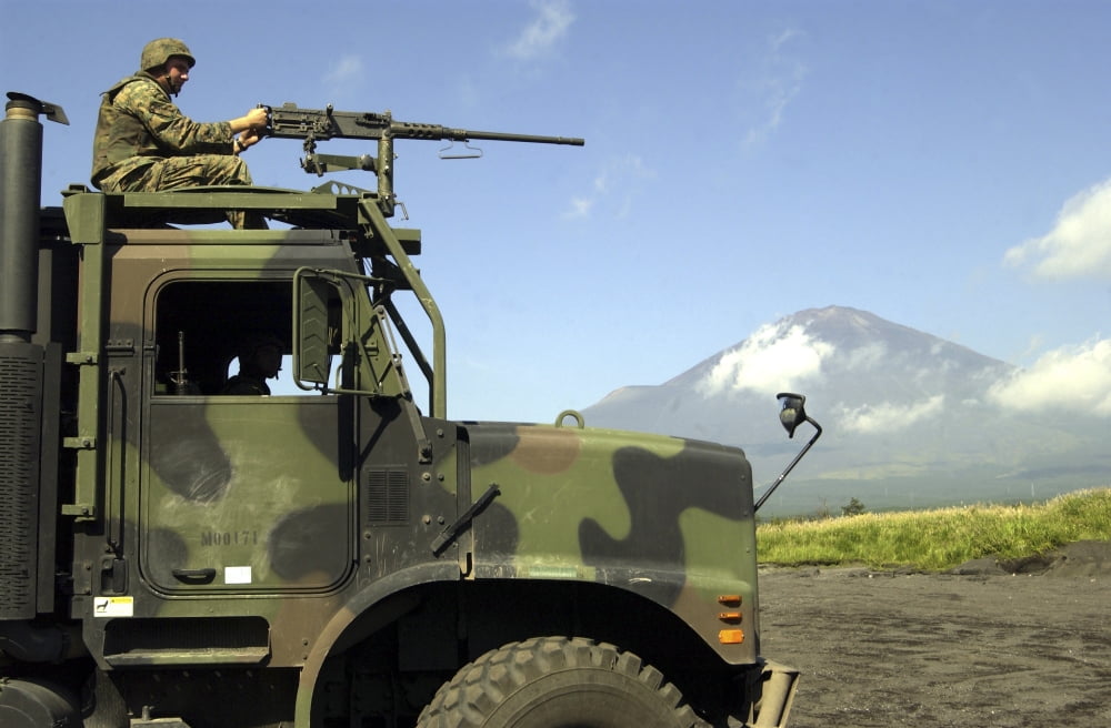 Soldier surveys the landscape with an M2 50 caliber machine gun atop a seven-ton truck Canvas Art - Stocktrek Images (34 x 23)