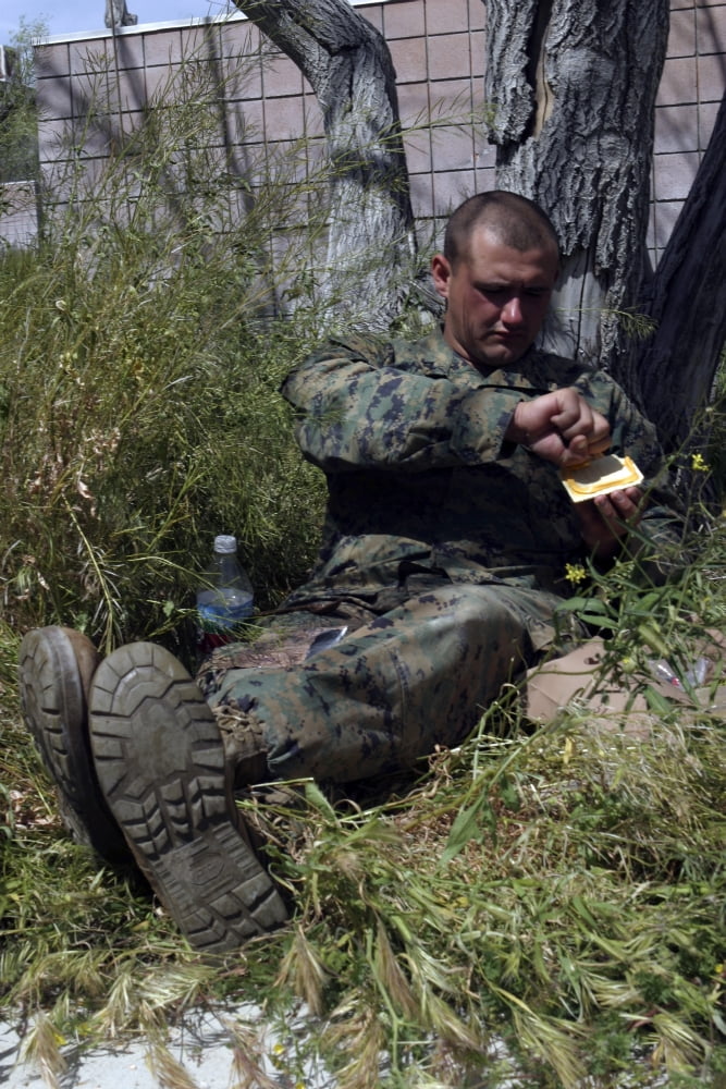 Soldier takes advantage of a break in training to eat Canvas Art - Stocktrek Images (23 x 35)