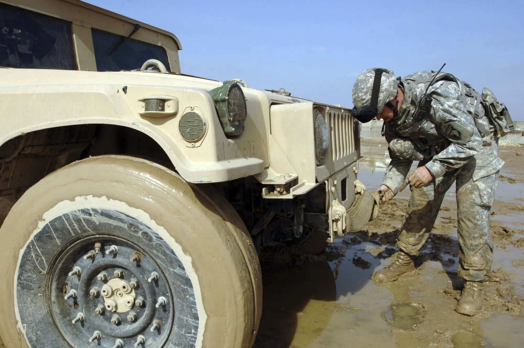 Soldier unties a rope to tow a humvee out of the mud Canvas Art - Stocktrek Images (34 x 23)