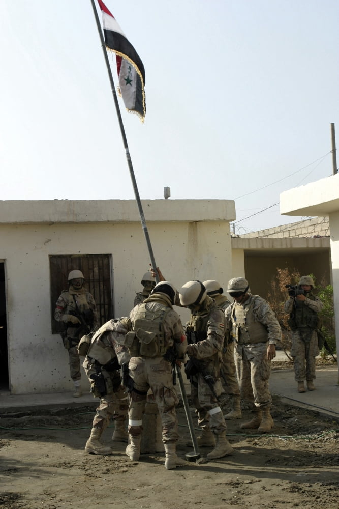 Soldiers from the Iraqi Special Forces raise the Iraqi National Flag in front of the office of the mayor of Fallujah Canvas Art - Stocktrek Images (23 x 34)