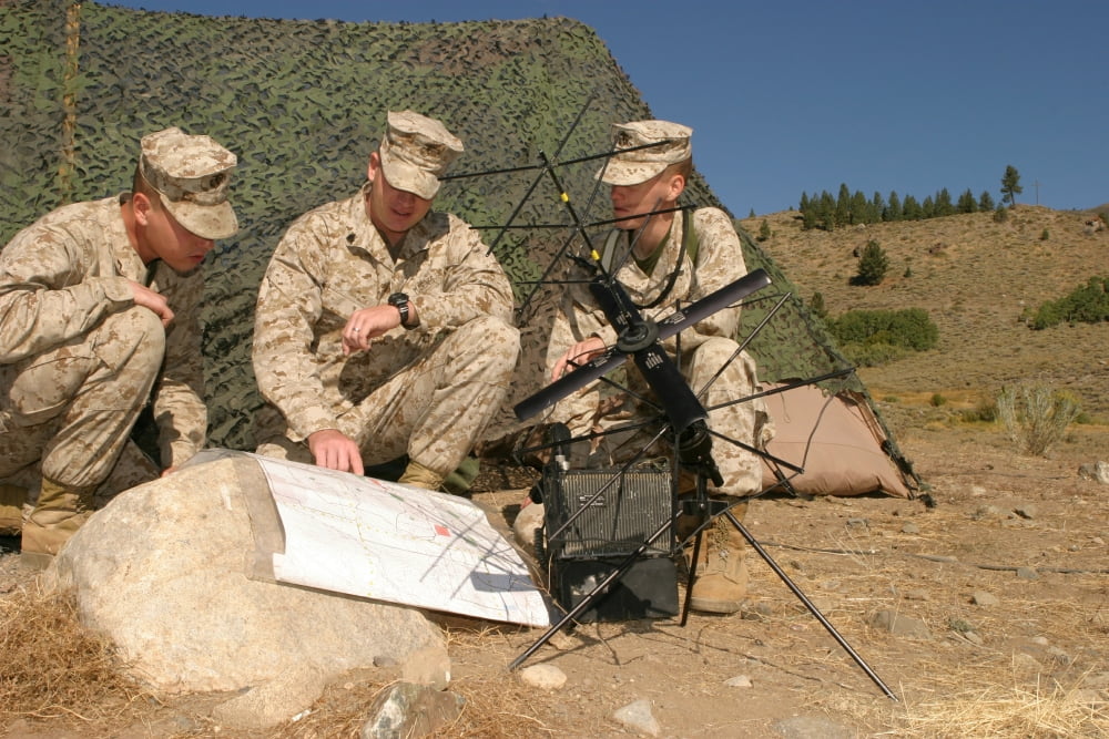 Soldiers analyze the finer points of a terrain map at a radio communications center Canvas Art - Stocktrek Images (34 x 23)