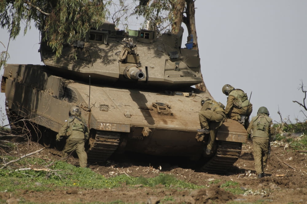 Soldiers climb into an Israel Defense Force Merkava Mark IV battle tank Canvas Art - Ofer ZidonStocktrek Images (35 x 23)