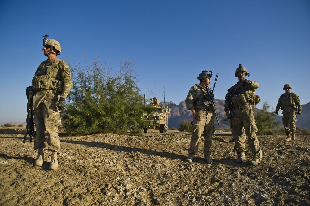 Soldiers discuss a strategic plan during an operation in Afghanistan Canvas Art - Stocktrek Images (35 x 23)