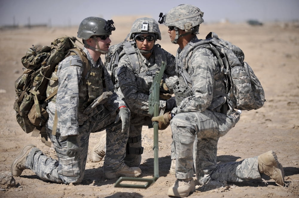Soldiers discuss a strategic plane during a training exercise Canvas Art - Stocktrek Images (34 x 23)
