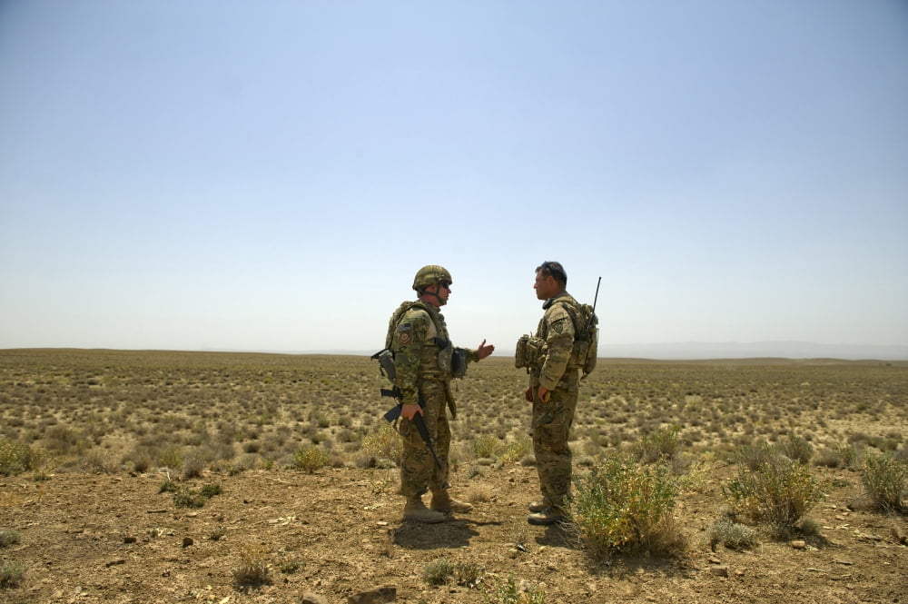 Soldiers discuss drop zone establishment procedures near an Afghan border Canvas Art - Stocktrek Images (35 x 24)
