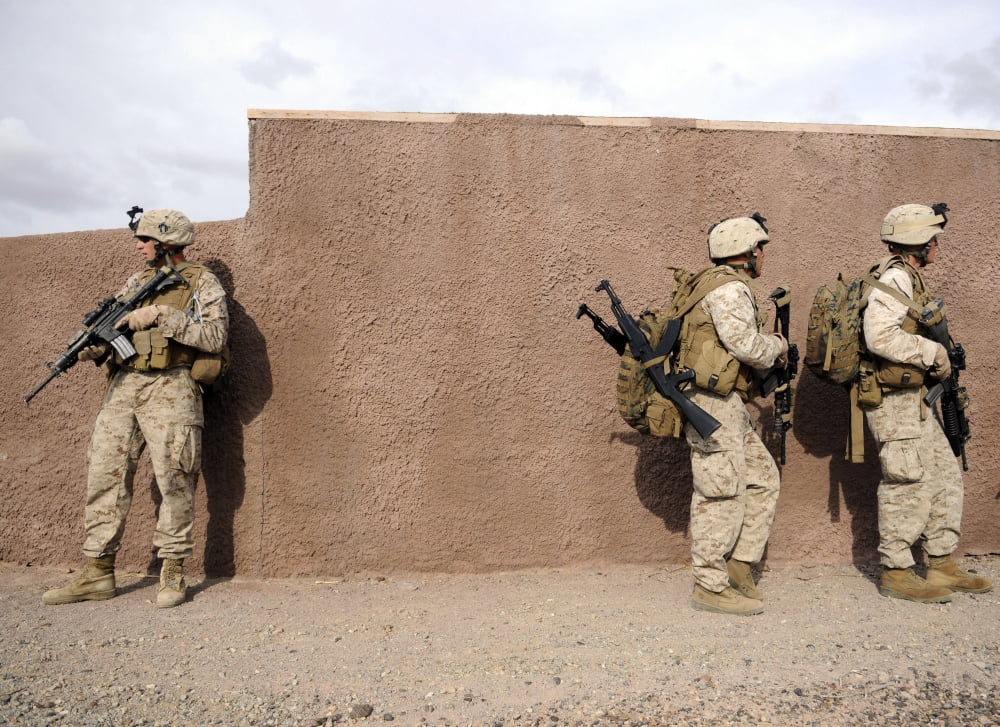 Soldiers halt behind a wall moments before rushing to a landing site for extraction Canvas Art - Stocktrek Images (33 x 24)