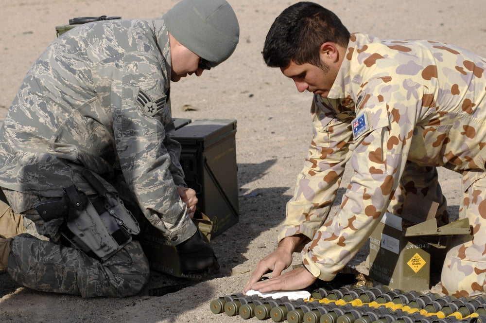 Soldiers lay down P-4 explosive material over ammunition during a controlled detonation Canvas Art - Stocktrek Images (34 x 23)