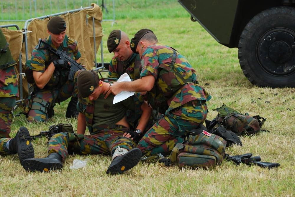 Soldiers of a Belgian Infantry unit helping out a wounded colleague on the field Canvas Art - Luc De JaegerStocktrek Images (34 x 23)